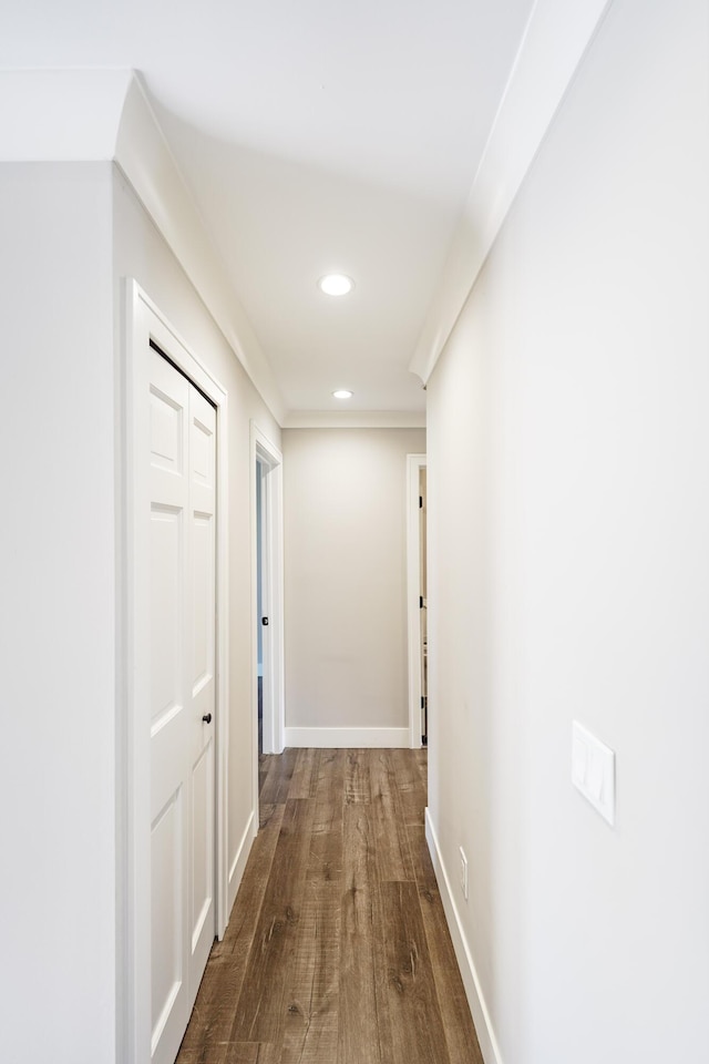 hall featuring recessed lighting, baseboards, and dark wood-style floors