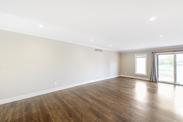 unfurnished room with visible vents, ornamental molding, baseboards, recessed lighting, and dark wood finished floors