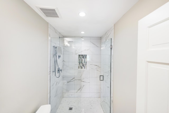 full bathroom featuring a marble finish shower, toilet, recessed lighting, and visible vents