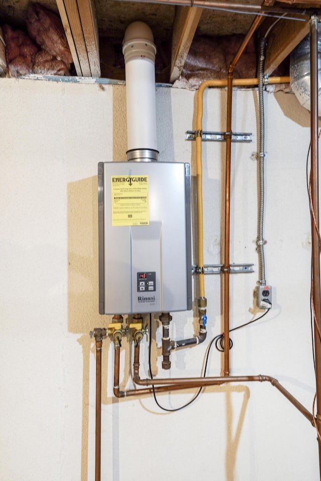 utility room featuring tankless water heater