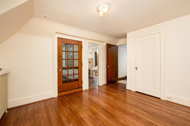 interior space featuring baseboards and wood finished floors