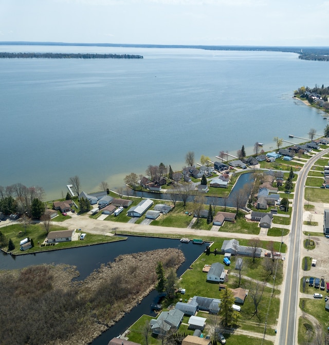 view of property location featuring a large body of water and nearby suburban area