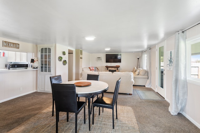 dining space featuring dark colored carpet and baseboards