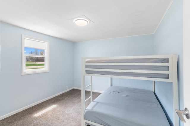 carpeted bedroom featuring baseboards and crown molding