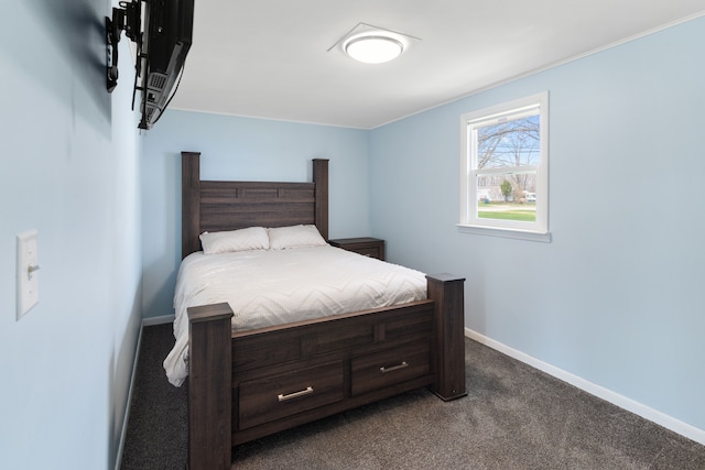 bedroom featuring dark carpet and baseboards