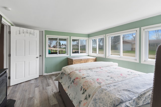 bedroom with wood finished floors and baseboards