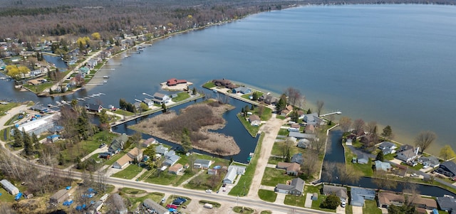 view of property location featuring a nearby body of water and nearby suburban area