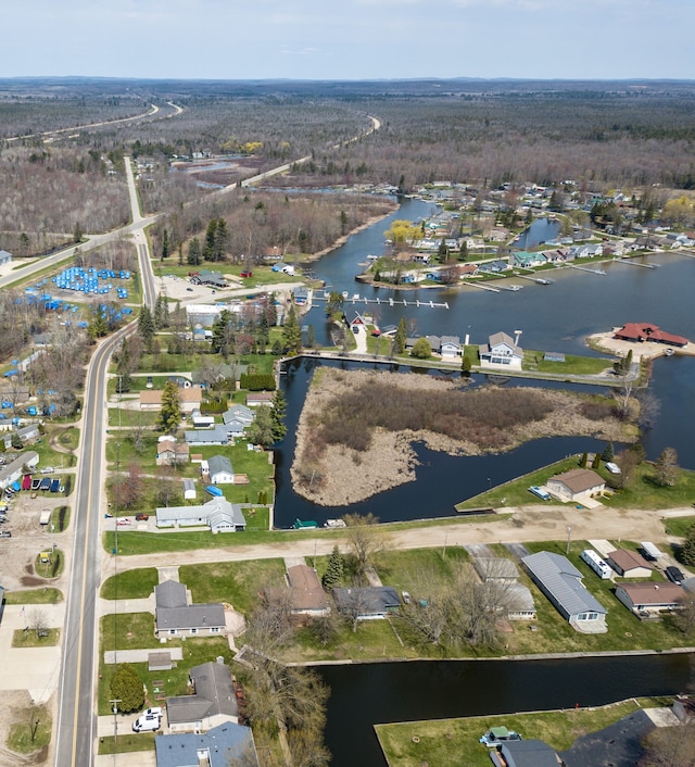 aerial view of property and surrounding area with a nearby body of water