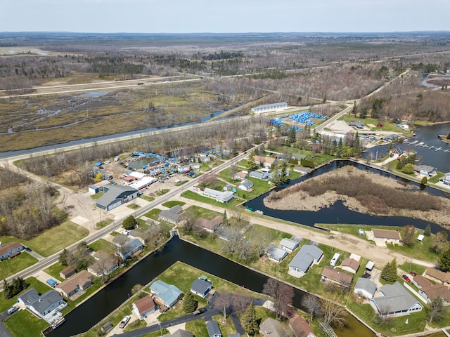 aerial view of property and surrounding area with a nearby body of water