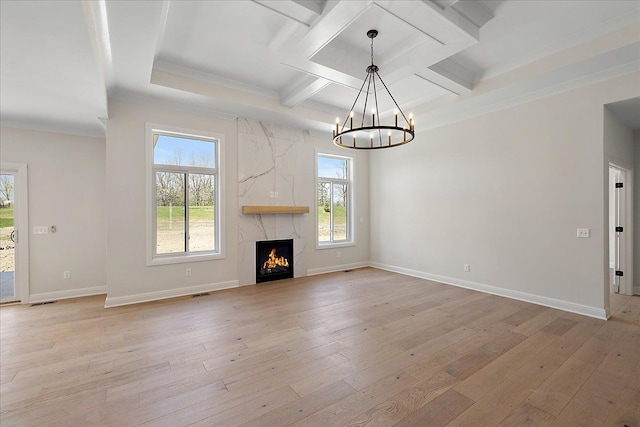 720 Marlayna Dr, Oxford, MI 48371 - unfurnished living room featuring light wood finished floors, a chandelier, baseboards, ornamental molding, and coffered ceiling