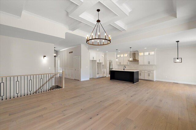 720 Marlayna Dr, Oxford, MI 48371 - unfurnished living room with light wood-style floors, visible vents, a notable chandelier, and beamed ceiling