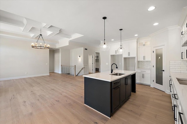 720 Marlayna Dr, Oxford, MI 48371 - kitchen with crown molding, recessed lighting, white cabinetry, a chandelier, and a sink