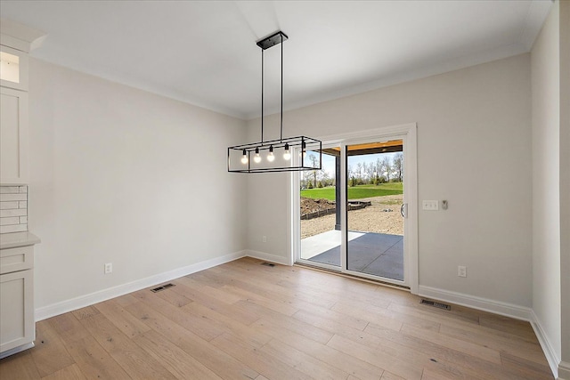 720 Marlayna Dr, Oxford, MI 48371 - unfurnished dining area featuring a notable chandelier, baseboards, visible vents, and light wood-style flooring