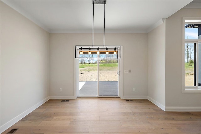 720 Marlayna Dr, Oxford, MI 48371 - unfurnished dining area featuring visible vents, light wood-style flooring, crown molding, and baseboards