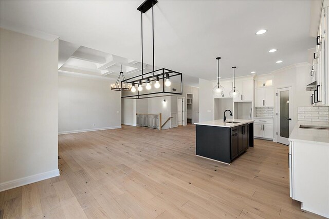 720 Marlayna Dr, Oxford, MI 48371 - kitchen with a sink, light countertops, open floor plan, recessed lighting, and white cabinetry