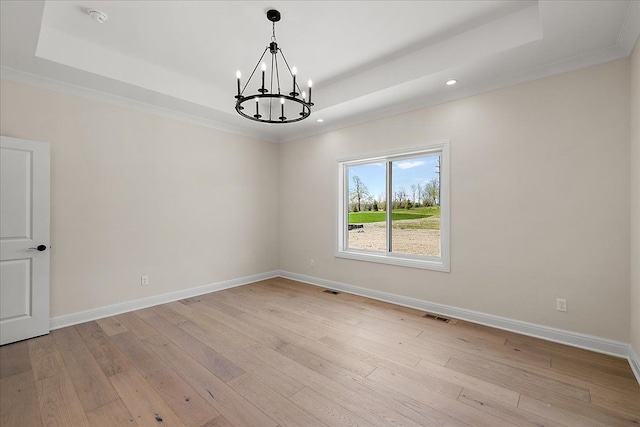 720 Marlayna Dr, Oxford, MI 48371 - unfurnished room featuring recessed lighting, light wood-style floors, a chandelier, and a tray ceiling