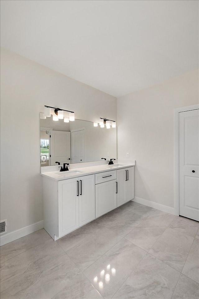 720 Marlayna Dr, Oxford, MI 48371 - full bathroom featuring baseboards, a sink, double vanity, and visible vents