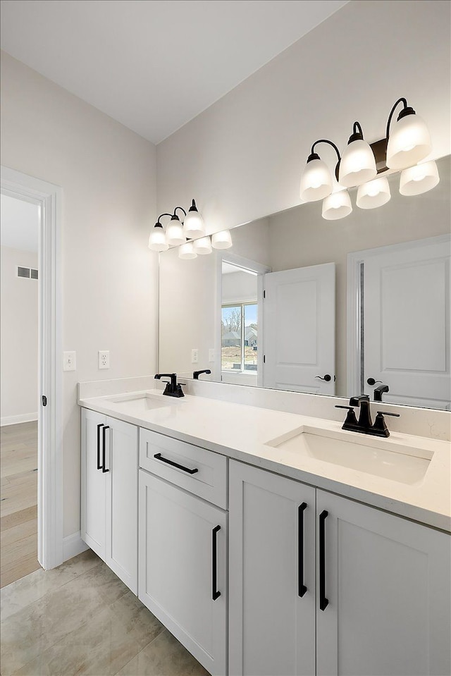 720 Marlayna Dr, Oxford, MI 48371 - full bath featuring visible vents, a sink, baseboards, and double vanity