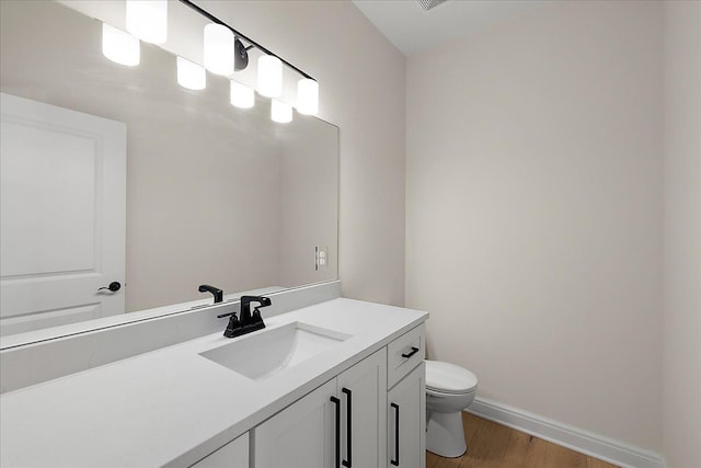 720 Marlayna Dr, Oxford, MI 48371 - bathroom with toilet, baseboards, wood finished floors, and vanity