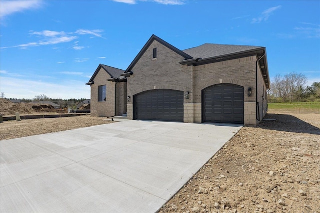 720 Marlayna Dr, Oxford, MI 48371 - view of front of house featuring an attached garage, driveway, and brick siding