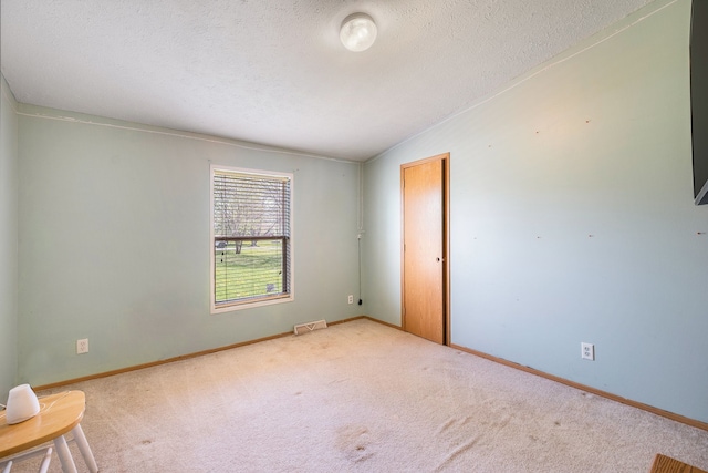 8239 Vanadia Dr, Mount Morris, MI 48458 - empty room featuring visible vents, a textured ceiling, carpet, and baseboards