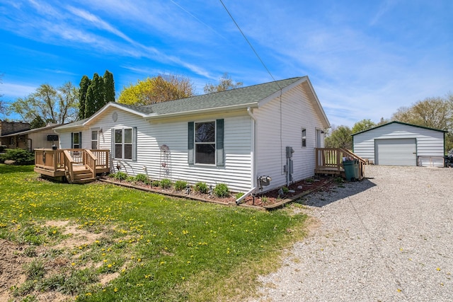 8239 Vanadia Dr, Mount Morris, MI 48458 - view of front of house with driveway, a wooden deck, a detached garage, an outdoor structure, and a front lawn