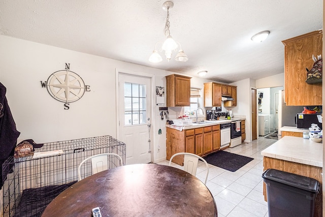 8239 Vanadia Dr, Mount Morris, MI 48458 - dining room with washer / dryer, light tile patterned flooring, baseboards, a textured ceiling, and a notable chandelier