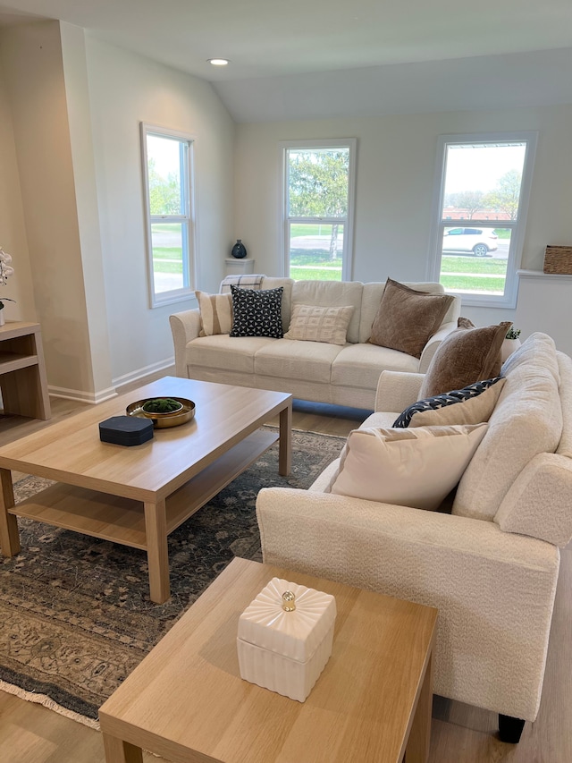 living room featuring baseboards, recessed lighting, and wood finished floors