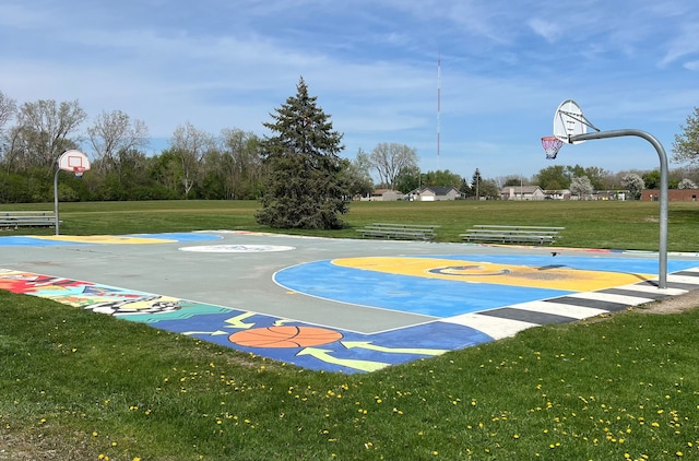 view of basketball court with community basketball court and a yard
