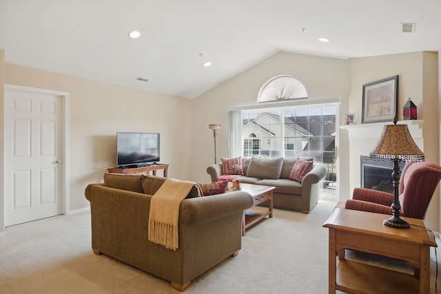 living room featuring baseboards, visible vents, light carpet, and lofted ceiling