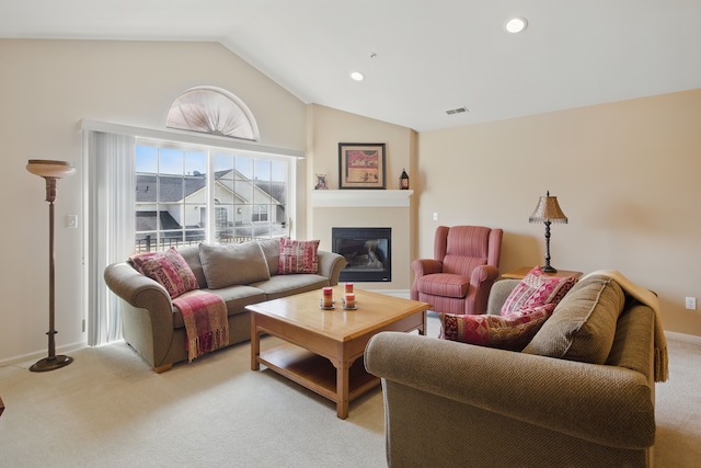 35202 Emma Cir, Walled Lake, MI 48390 - living area featuring light colored carpet, vaulted ceiling, a glass covered fireplace, and recessed lighting