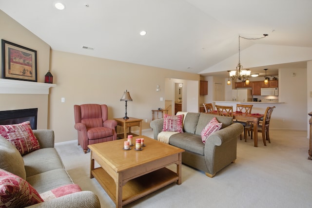 living room with visible vents, an inviting chandelier, lofted ceiling, light carpet, and baseboards