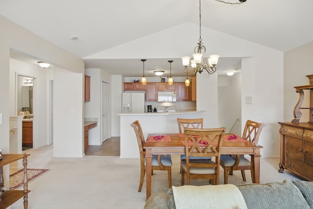dining space with a notable chandelier, vaulted ceiling, and light colored carpet