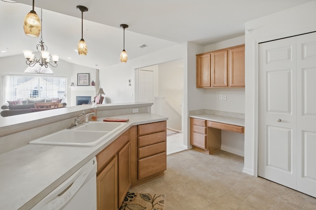 kitchen featuring white dishwasher, built in desk, a sink, light countertops, and visible vents