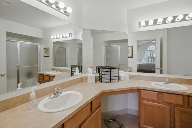full bath featuring connected bathroom, a shower stall, and a sink