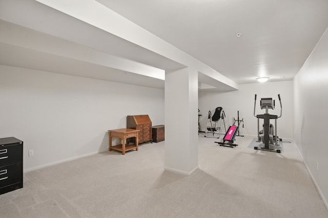 exercise area featuring carpet floors and baseboards