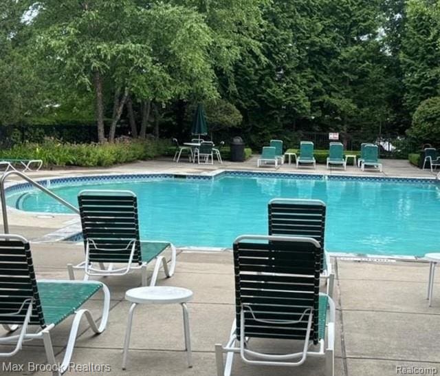 35202 Emma Cir, Walled Lake, MI 48390 - community pool featuring a patio and view of scattered trees