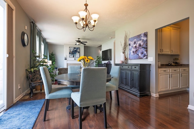 1813 Garfield St, Howell, MI 48855 - dining area with a chandelier, dark wood-type flooring, a ceiling fan, and baseboards