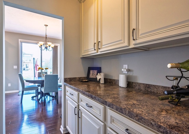 1813 Garfield St, Howell, MI 48855 - kitchen with an inviting chandelier, dark countertops, dark wood-type flooring, baseboards, and decorative light fixtures