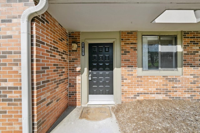 property entrance with brick siding