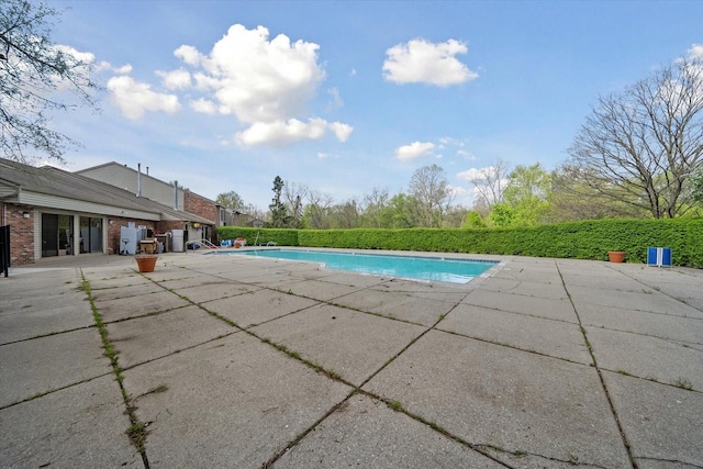 view of swimming pool with a patio and a fenced in pool