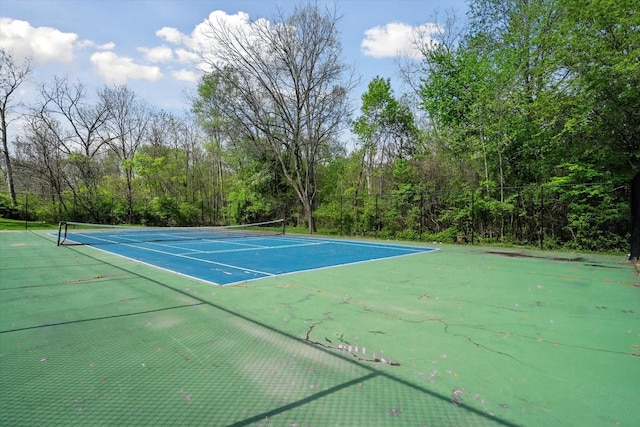 view of tennis court featuring fence