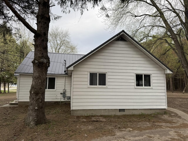 8854 E Pickard Rd, Mount Pleasant, MI 48858 - view of property exterior with crawl space and metal roof