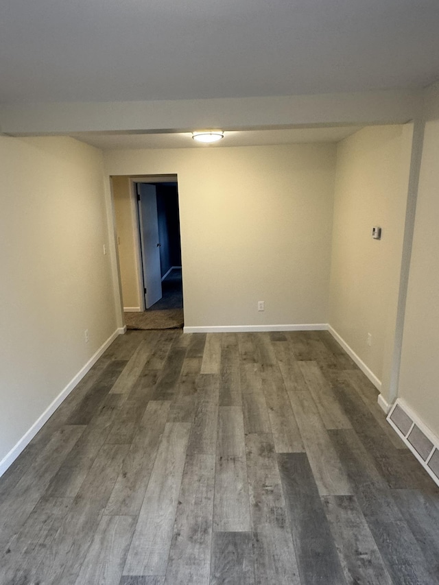 8854 E Pickard Rd, Mount Pleasant, MI 48858 - finished below grade area with dark wood-type flooring, baseboards, and visible vents