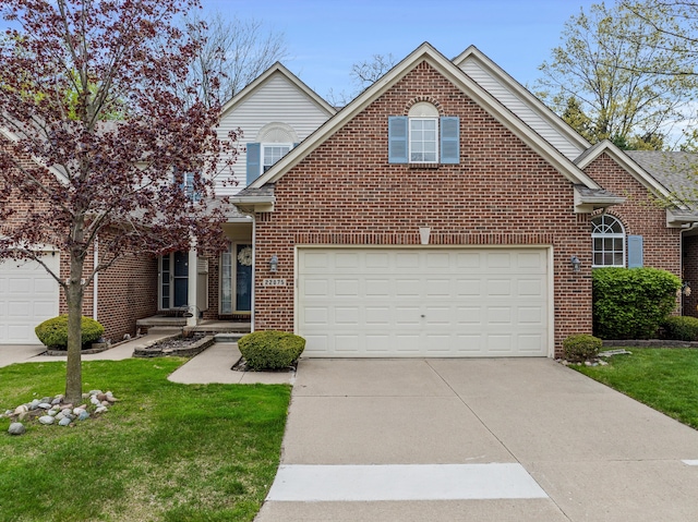traditional home with concrete driveway, brick siding, a garage, and a front lawn