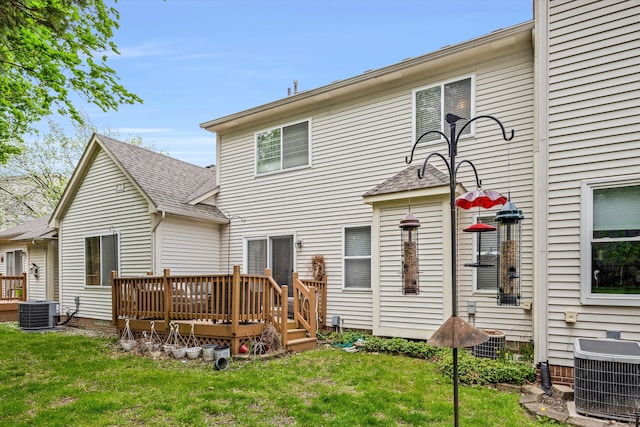 rear view of property with roof with shingles, a yard, a wooden deck, and cooling unit