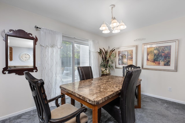 dining room with baseboards, dark carpet, and a chandelier