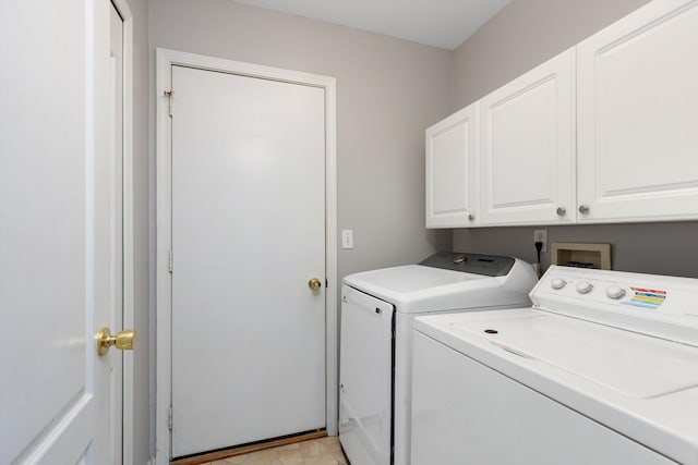 laundry area featuring washing machine and dryer and cabinet space