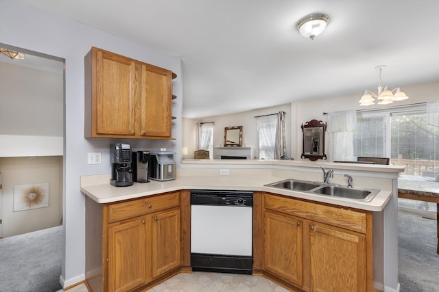 kitchen featuring a peninsula, a chandelier, a healthy amount of sunlight, and dishwasher