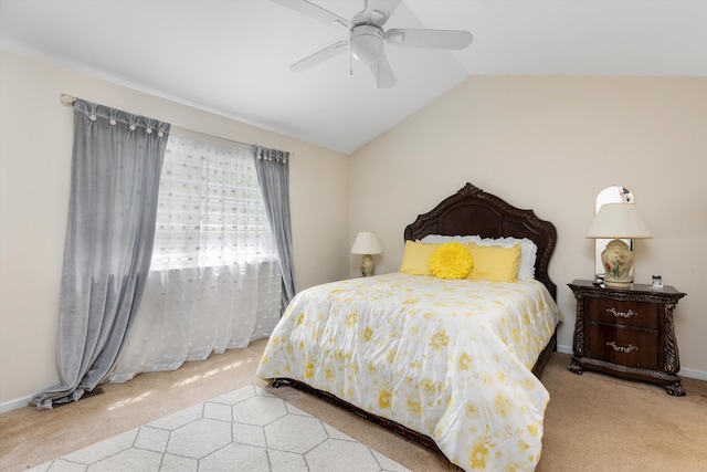carpeted bedroom with baseboards, ceiling fan, and vaulted ceiling